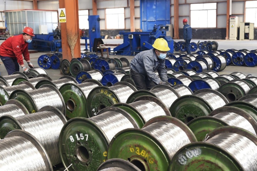 Workers move rolls of aluminium at a factory in Zouping county in east China's Shandong province, Saturday, April 7, 2018. Unwilling to yield, US President Donald Trump and China's government escalated their trade clash Friday, with Beijing vowing to "counter-attack with great strength" if Trump follows through on threats to impose tariffs on an additional $100 billion in Chinese goods. Photo: Chinatopix via AP