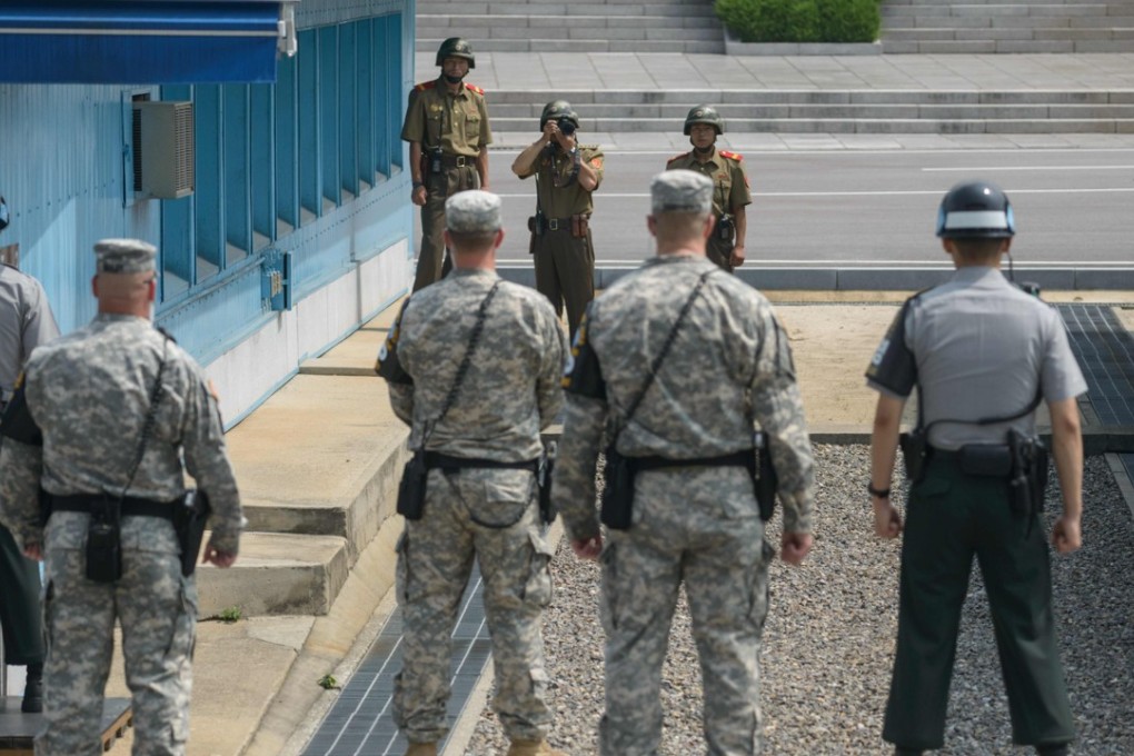 North Korean soldiers take photos of US soldiers in the truce village of Panmunjom. Photo: AFP