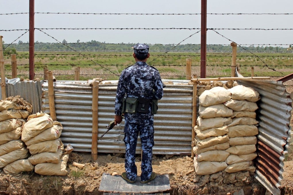 A Myanmar border guard near the Taung Pyo Letwe camp overlooking the border with Bangladesh. Photo: Reuters