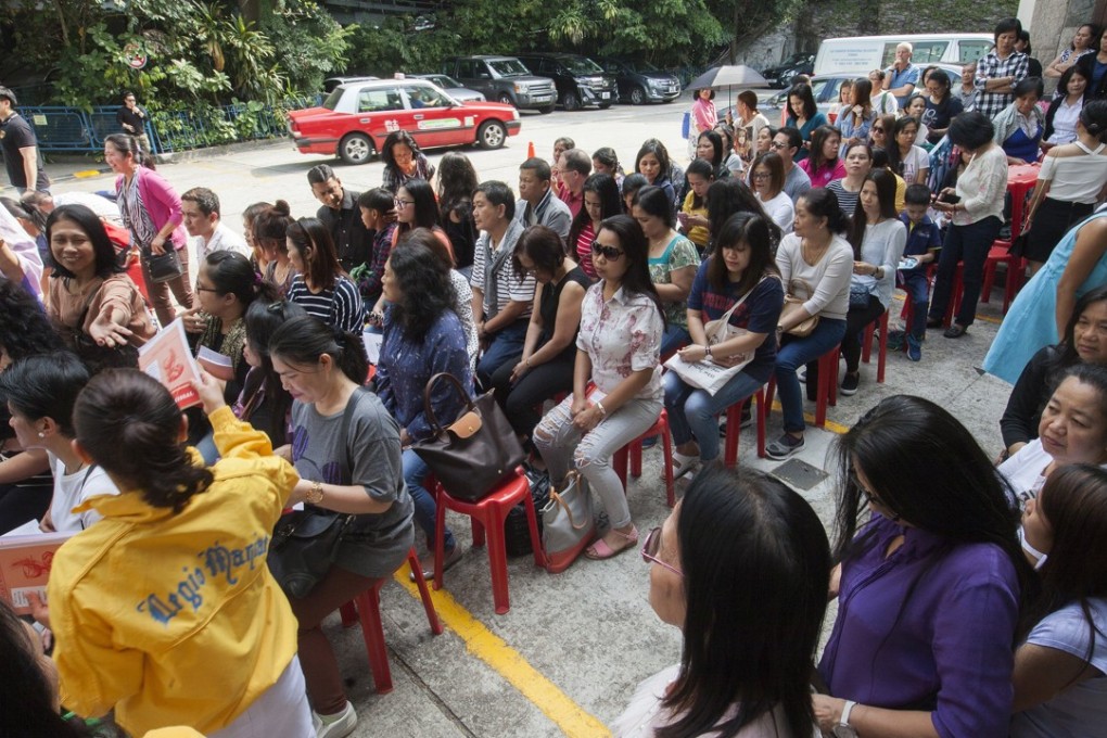 Domestic helpers from the Philippines attend Good Friday mass at St Joseph’s Church in Central, on March 30. Economic hardships and social stigma can impinge on the mental health of minority populations. Photo: EPA-EFE