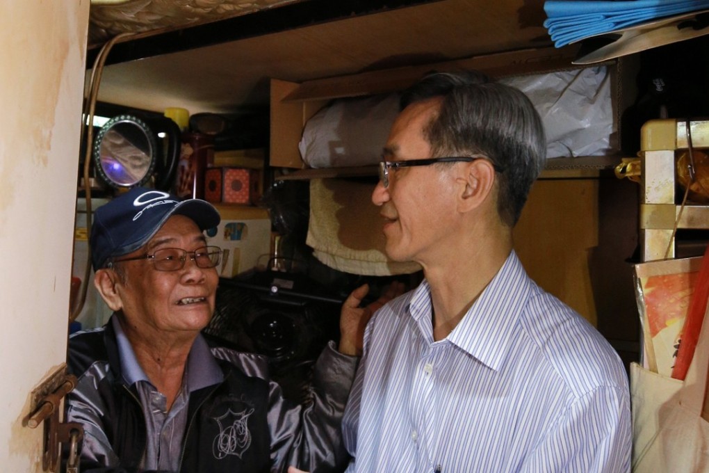 The chairman of Hong Kong’s Task Force on Land Supply, Stanley Wong Yuen-fai (right), visits elderly residents of subdivided flats in Sham Shui Po on April 29. Photo: Handout