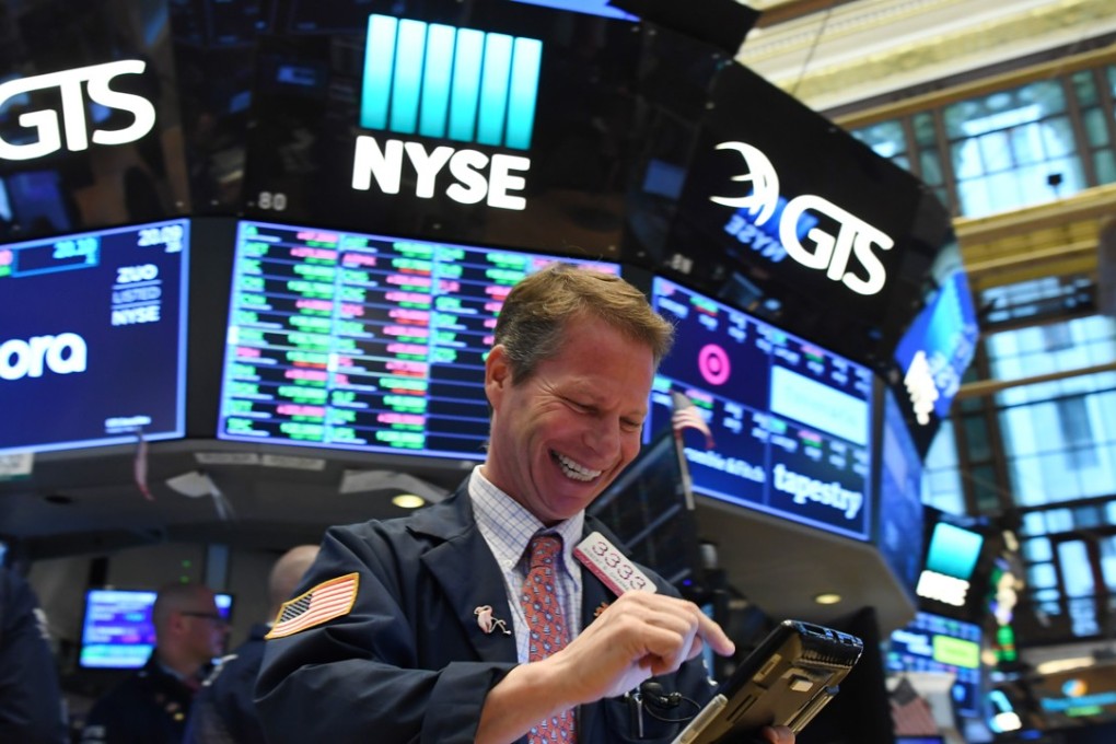 A trader at the New York Stock Exchange smiles as US stocks close higher on April 12. Stocks have enjoyed a bull run under the Trump administration and corporate stock buy-backs have been the major source of demand for American equities. Photo: Xinhua