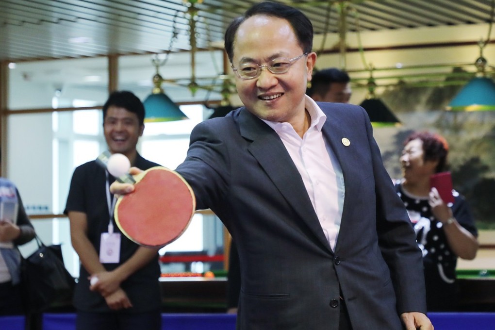 Wang Zhimin, head of the central government’s liaison office in Hong Kong, plays table tennis during the office’s open day on April 28. Wang has invited the city’s pan-democratic legislators to visit his office in Western. Photo: Edward Wong
