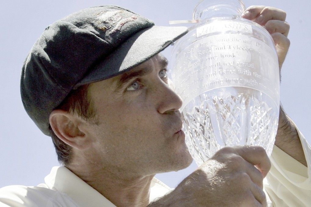 New Australia coach Justin Langer kisses the Ashes trophy during his playing days. Photo: AP