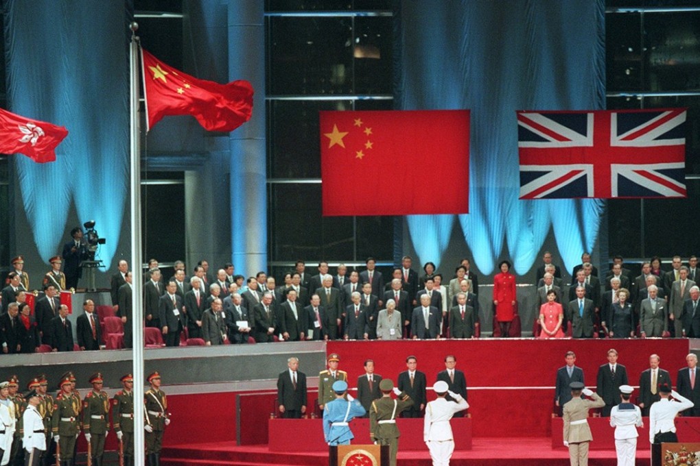 Dignitaries from either side stand as the British flag is lowered to mark the People’s Republic of China resuming its exercise of sovereignty over Hong Kong, on July 1, 1997. Photo: SCMP Pictures