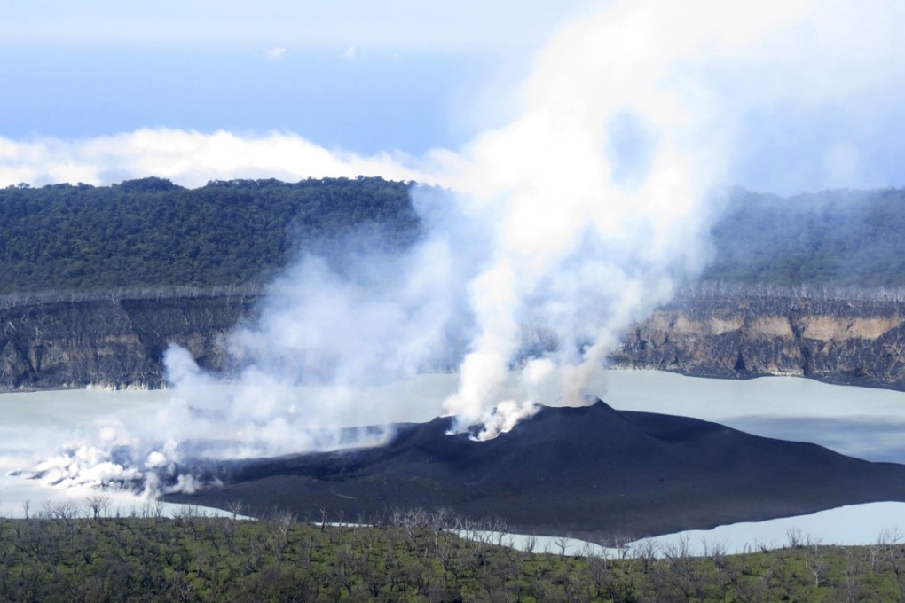 Steam rises from the volcanic cone that has formed in Lake Vui near the summit of Ambae Island, Vanuatu. Photo: AP