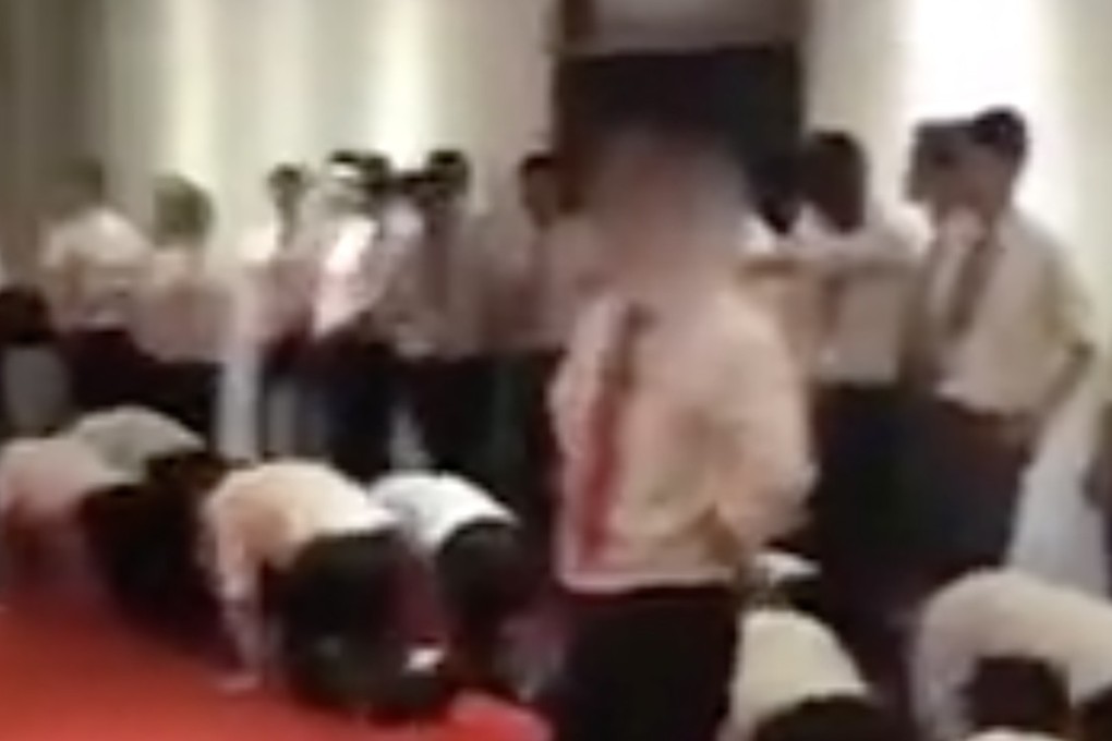 Staff crawling on the floor during the company meeting. Photo: Sina