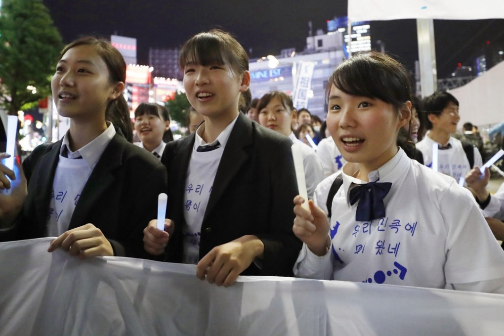 Korean residents of Japan hold carry a unification flag during a rally in Tokyo. Photo: Kyodo