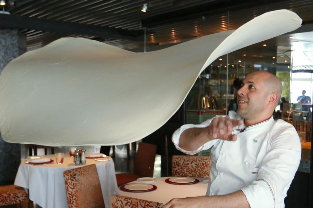 Pasqualino Barbasso, two-time world champion of pizza acrobatics shows his skill at Cucina, Marco Polo Hong Kong Hotel in Tsim Sha Tsui. Photo: Edmond So