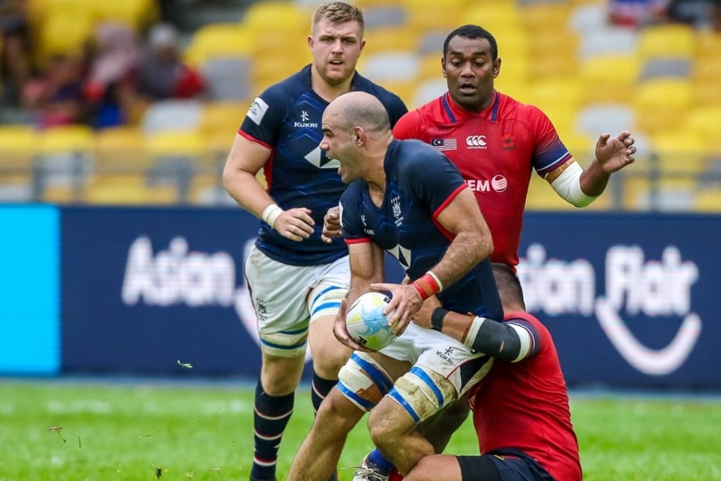Thomas Lamboley looks for support as he is tackled by Malaysia during Saturday’s Asia Rugby Championship match in Kuala Lumpur. Photo: Handout