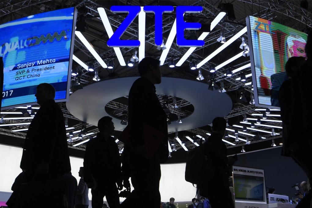 People walk by the ZTE stand at the Mobile World Congress (MWC) in Barcelona. Photo: AFP