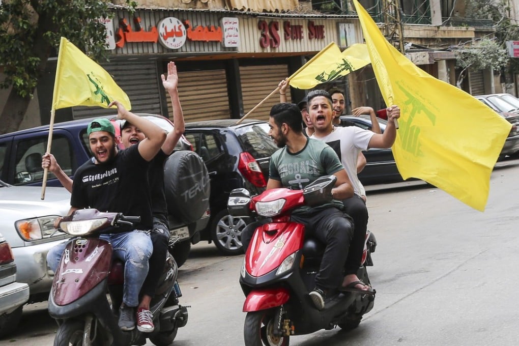 Hezbollah supporters carry their party flags and ride motorcycles at the southern suburb of Beirut, Lebanon after the first parliamentary elections in nine years. Photo: EPA