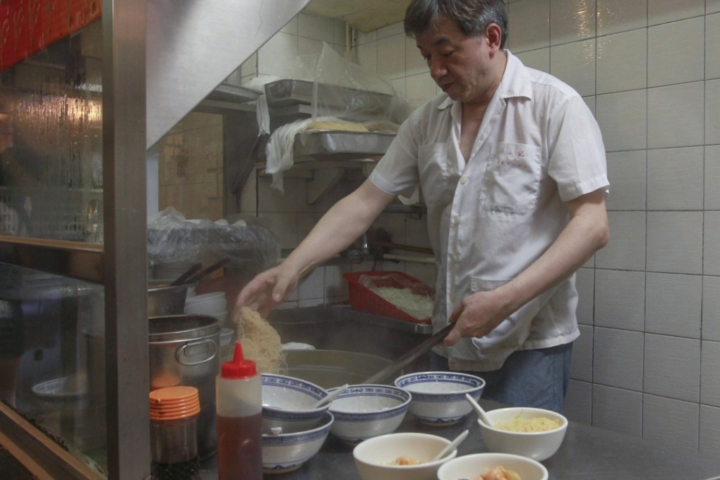 Chan Siu-lung cooks wonton noodles in the kitchen at Mak An Kee Noodles in Central. Shrimp wonton noodles, it may be argued, could be the dish that best represents Hong Kong. Photo: Edward Wong