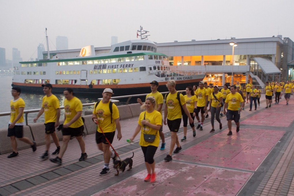 Participants walk along the harbourfront during the 2017 Darkness into Light walk.