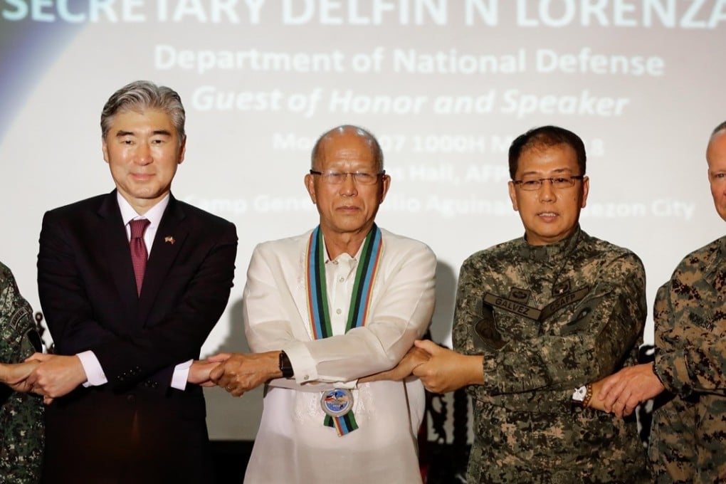 US Ambassador the Philippines Sung Kim and Philippines Defence Secretary Delfin Lorenzana join hands during the opening ceremony for the Philippines-United States Exercise Balikatan (Shoulder to Shoulder) 2018. Photo: EPA