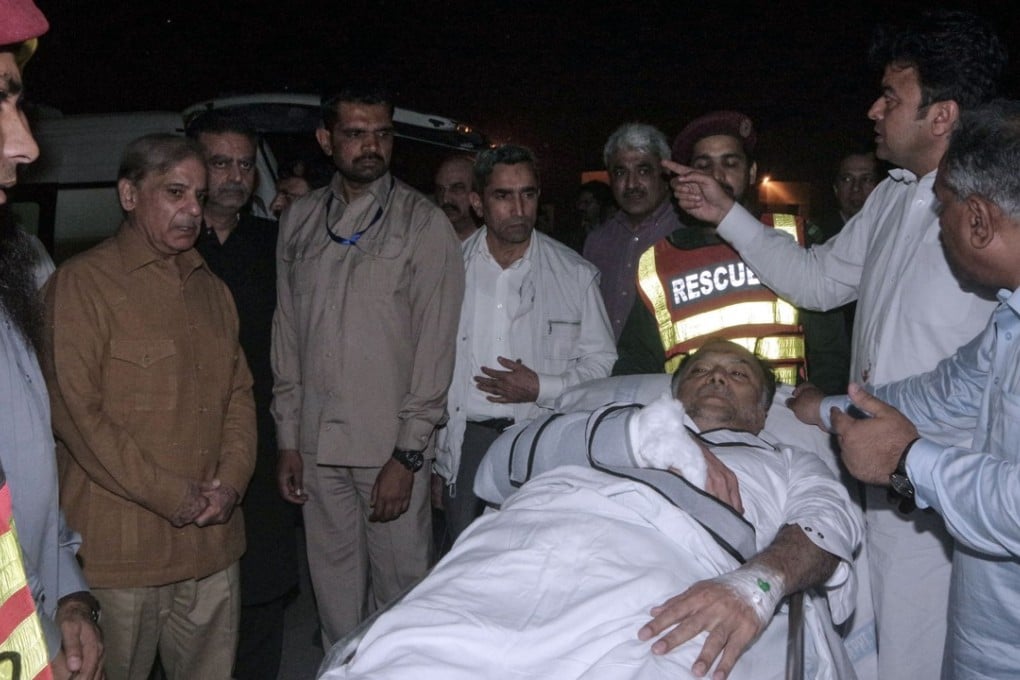 Injured Pakistani Interior Minister Ahsan Iqbal is evacuated from a helicopter after arriving in Lahore following his shooting. His shooter is linked to. Photo: Pakistani Press Information Department (PID) handout via AFP