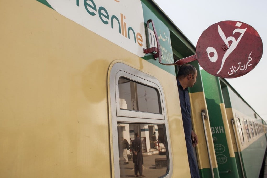 A passenger looks out from a coach of a Pakistan Railways Green Line Express train, at a station in Punjab province, on February 20. Beijing is upgrading a nearly 1,900km track from Karachi to Peshawar near the Afghan border with an US$8 billion loan to Pakistan, as part of the “Belt and Road Initiative”. Photo: Bloomberg