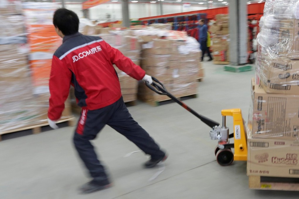 A worker moves goods at a JD.com logistics centre in Langfang, Hebei province. Photo: Reuters