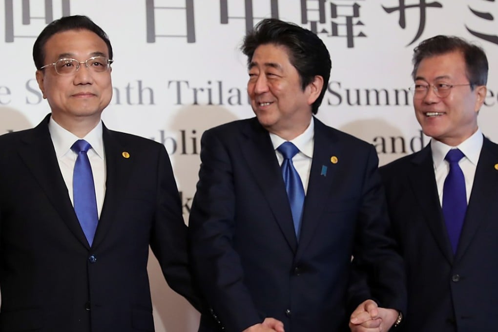 Chinese Premier Li Keqiang (left), Japanese Prime Minister Shinzo Abe (centre) and South Korean President Moon Jae-in pose for a photograph at the three nations’ summit in Tokyo. Photo: EPA-EFE
