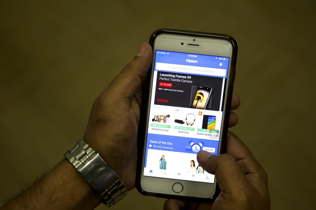 A man checks the Flipkart site on his smartphone in New Delhi, India, on Wednesday. With its acquisition of Flipkart, Walmart is breaking into a fast-growing economy where it has struggled to establish a foothold. Photo: AP