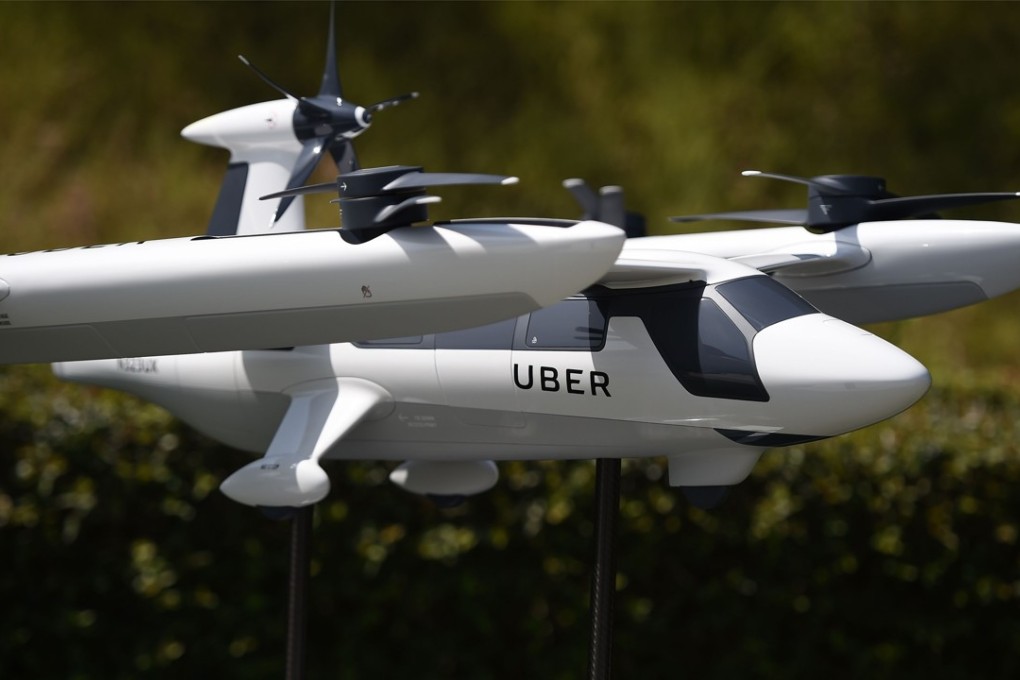 A model of Uber's electric vertical take-off and landing vehicle concept (eVTOL) flying taxi is displayed at the second annual Uber Elevate Summit, on May 8, 2018 at the Skirball Center in Los Angeles, California. Uber introduced it's electric powered "flying taxi" vertical take-off and landing concept aircraft at the event, which showcases prototypes for UberAir's fleet of airborne taxis. / AFP PHOTO / Robyn Beck