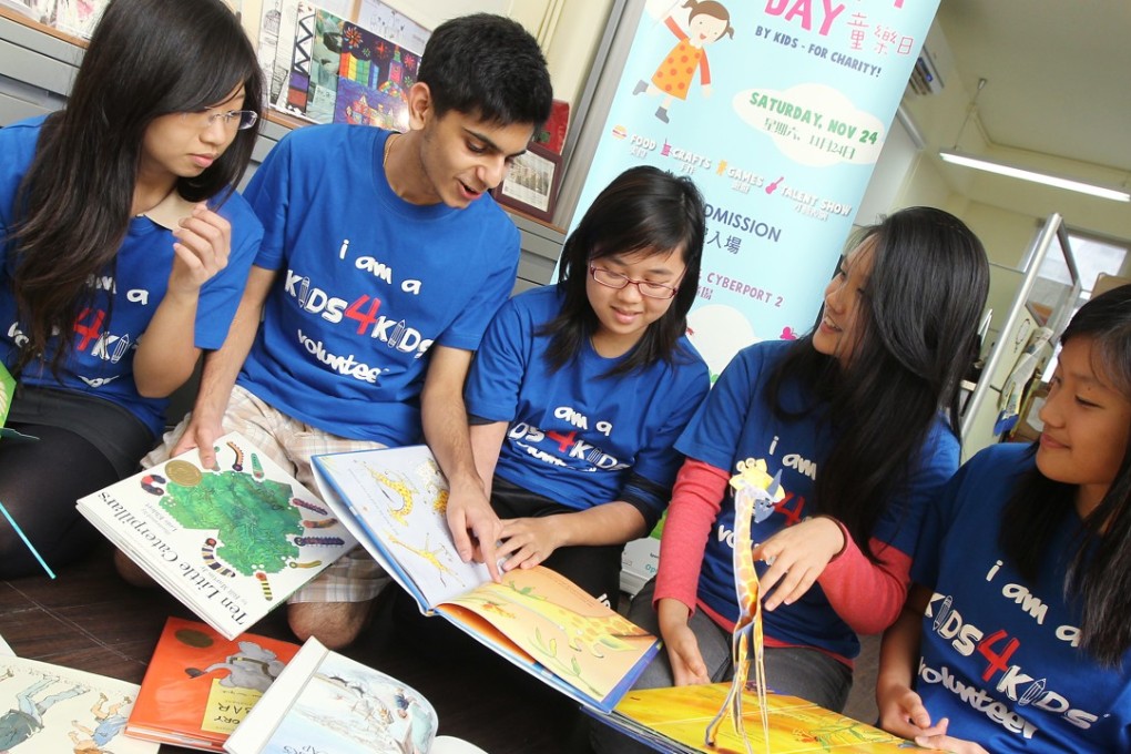 Secondary school volunteers of the Kids4Kids youth-oriented NGO share the joys of reading, in November 2012. Photo: K.Y. Cheng