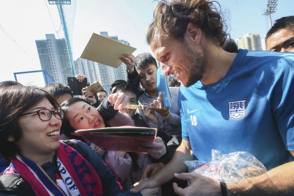 A fan meets Diego Forlan at the Kitchee Training Centre in Shek Mun. Photo: David Wong