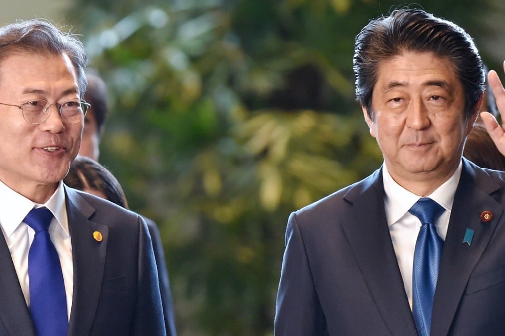 Moon Jae-in, South Korea's president, is greeted by Shinzo Abe, Japan's prime minister, at the trilateral summit in Tokyo. Photo: Bloomberg