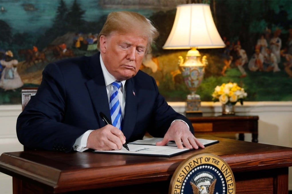 US President Donald Trump signing a proclamation declaring his intention to withdraw from the JCPOA Iran nuclear agreement in the Diplomatic Room at the White House in Washington on Tuesday. Photo: Reuters
