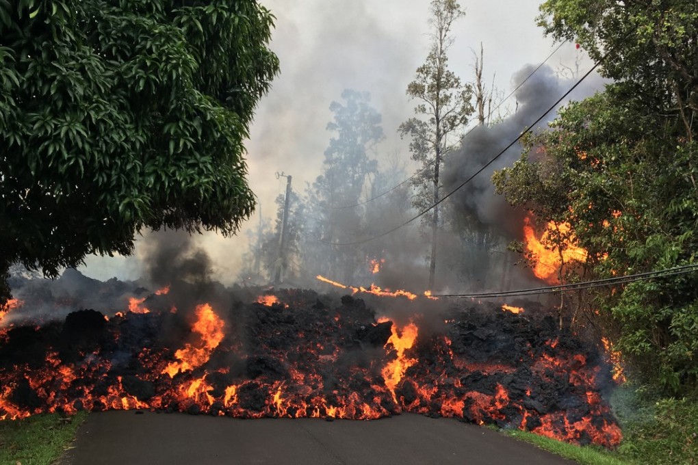 A lava flow moves down a street in the Leilani Estates on Hawaii's Big Island on Sunday. On Wednesday more people were evacuated from their homes as toxic gases and more lava were vented into a neighbourhood. Photo: US Geological Survey