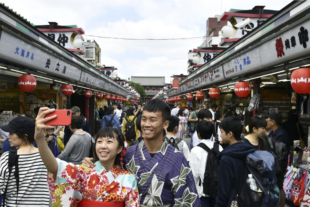 Tourists on a busy street in Asakusa, Tokyo, contributing to what Japan is calling its “tourism pollution”. Picture: Kyodo