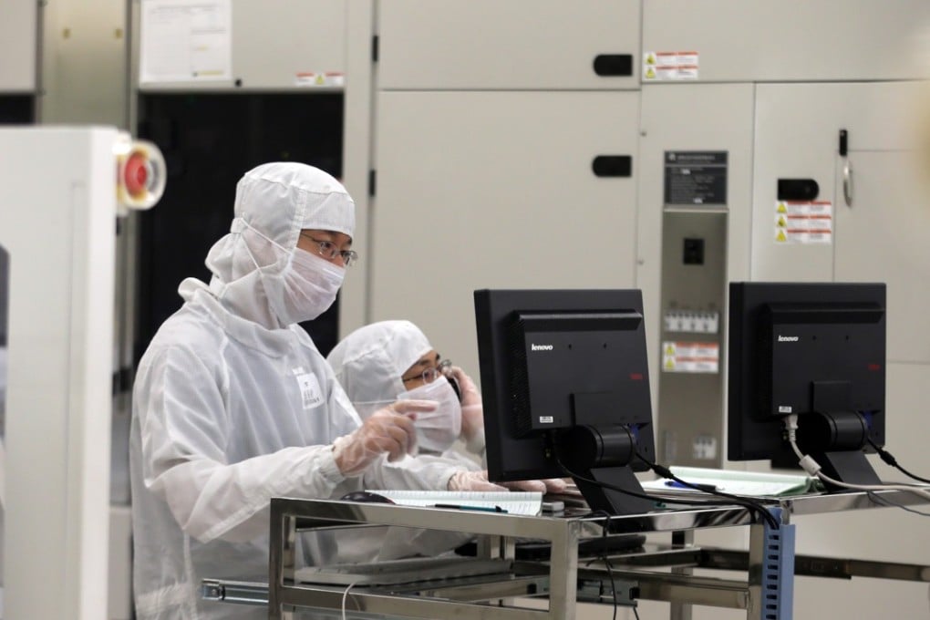 Employees dressed in dustproof clothing work at a chip wafer plant in mainland China operated by Hong Kong-listed Semiconductor Manufacturing International Corp, one of the early investee companies of the China National Integrated Circuit Industry Investment Fund. Photo: Handout