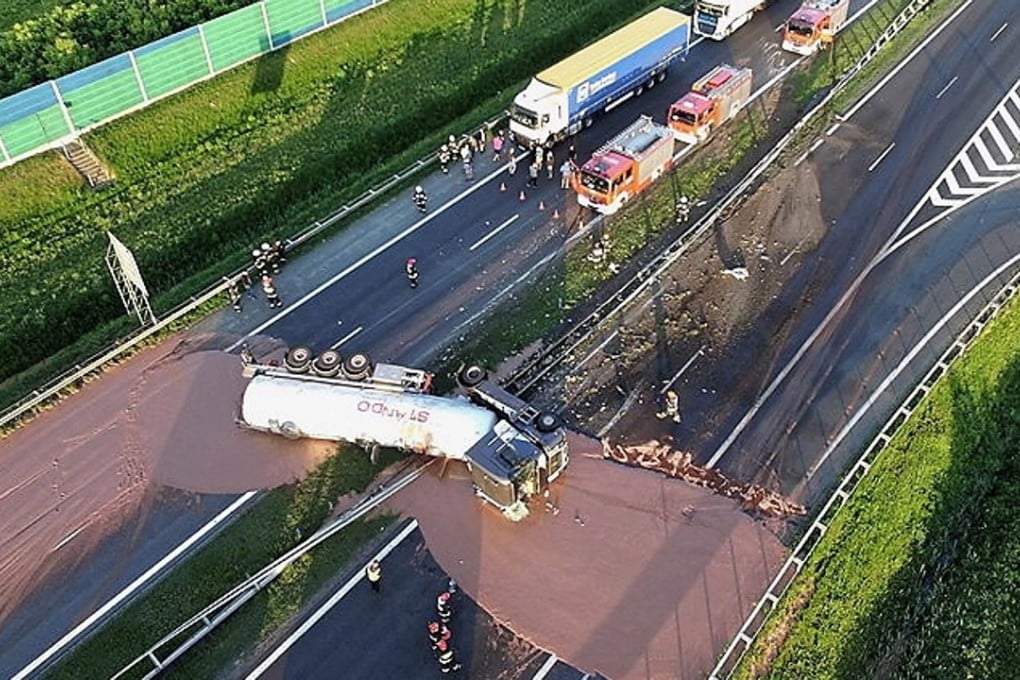 A slick of liquid chocolate burst from a crashed tanker truck and blocked both directions of a highway in Poland. Photo: EPA