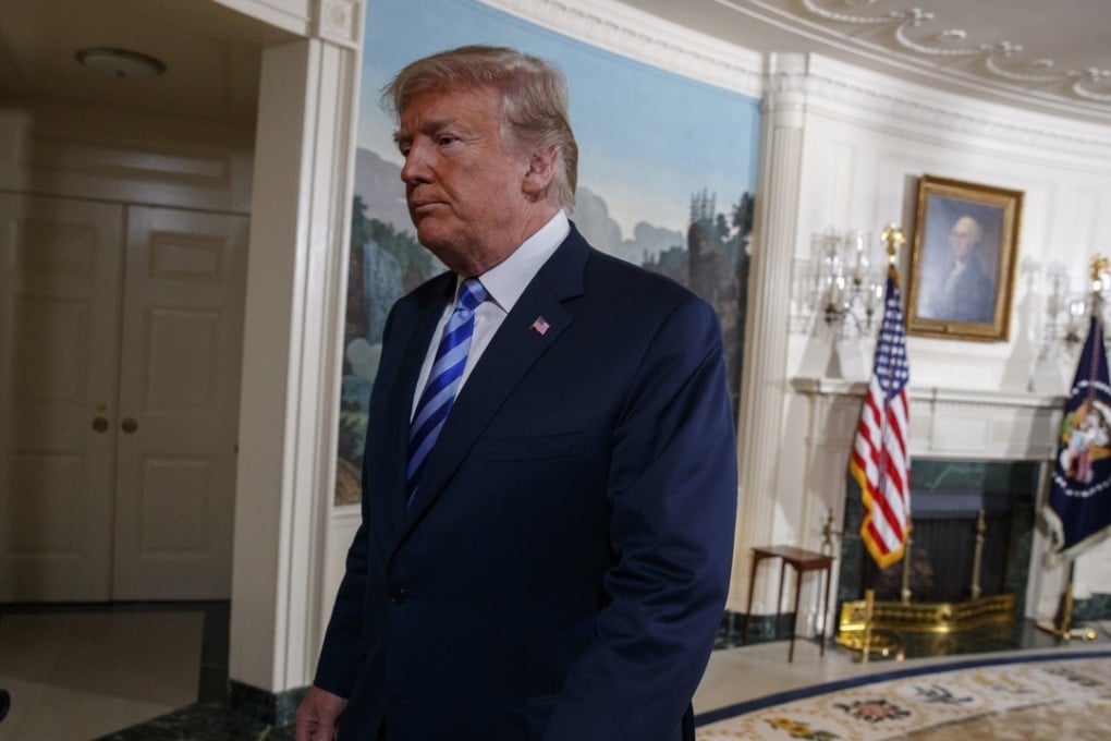 US President Donald Trump walks off after delivering a statement on the Iran nuclear deal from the Diplomatic Reception Room of the White House on Tuesday. Photo: AP