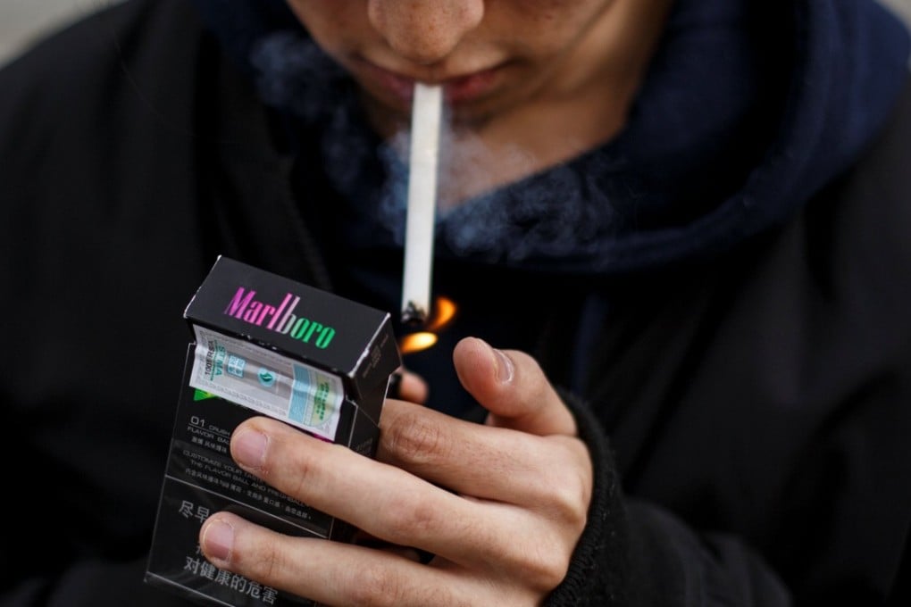 Student He Bingzhang lights a Marlboro cigarette in Beijing, China, on April 8, 2018. Photo: Reuters