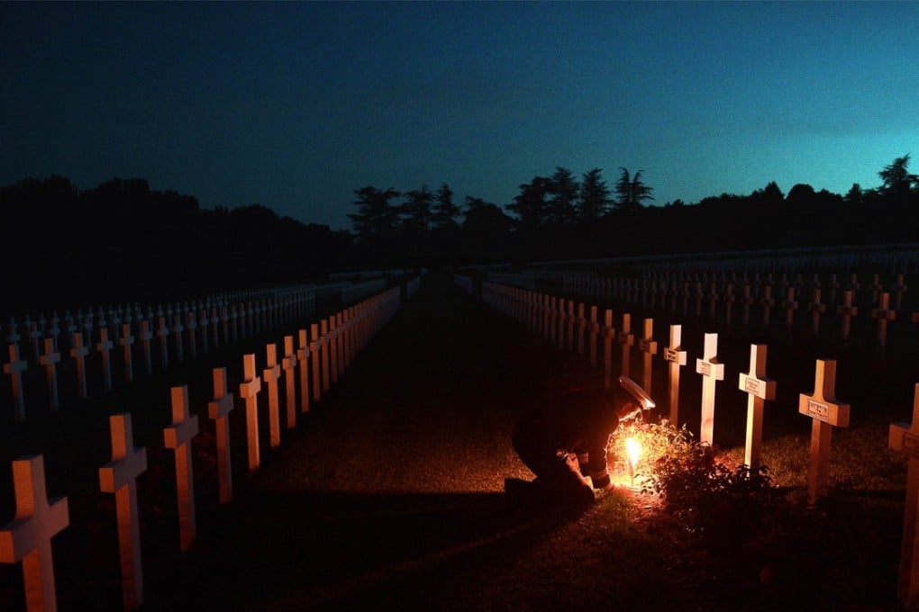 Torchlights are placed next to soldiers' tombs at the Douaumont ossuary and cemetery in eastern France, to commemorate the Battle of Verdun, one of the longest battles of the first world war. Photo: AFP