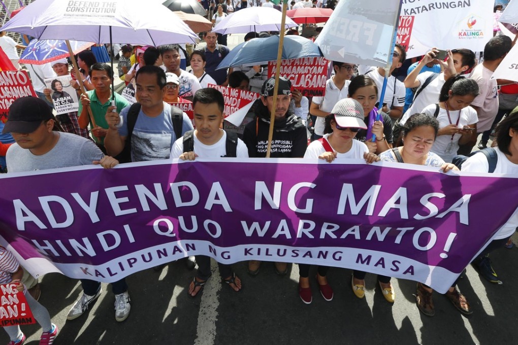 Protesters display placards in front of the Philippine Supreme Court. Photo: AP