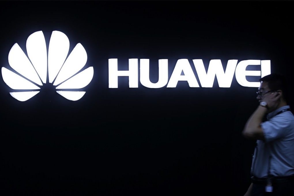 A man walks past a Huawei logo during a launch event for the Huawei Matebook in Beijing in 2016. Huawei is making bitcoin easier to access on its phones. Photo: AP