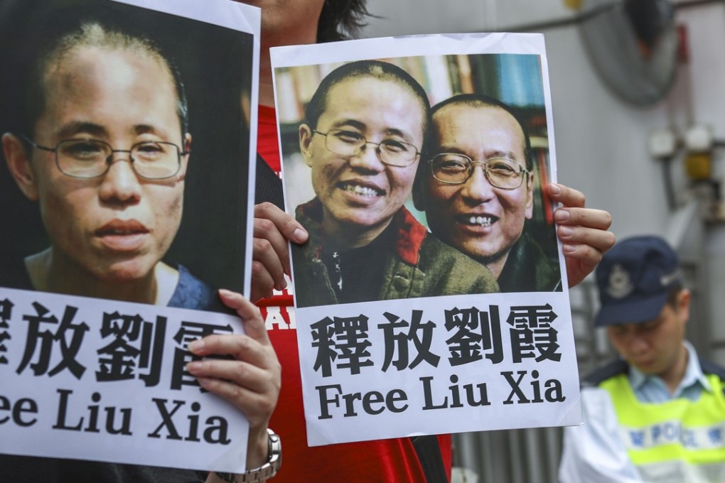 Pro-democracy protesters call for the release of Liu Xia as they lead a rally to the central government’s liaison office in Hong Kong on March 4. The poster on the right shows Liu Xia with her husband, the late Nobel laureate and political dissident Liu Xiaobo. Photo: Nora Tam