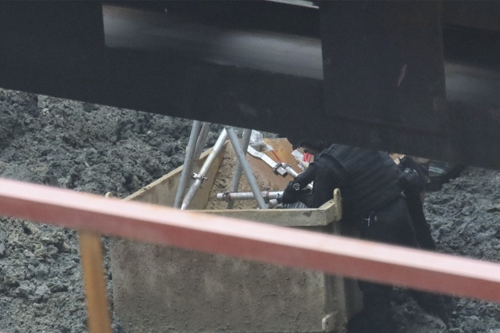 A bomb disposal expert works on the 450kg (1,000lbs) wartime bomb that was discovered at a construction site in Wan Chai. Photo: Felix Wong