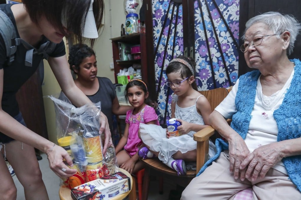 The food Sharanya Crosbie (centre left) and daughter Kaishori Crosbie (centre) packed as it was delivered to Lai Tsui-king, 83, in Lai King. Photo: Jonathan Wong