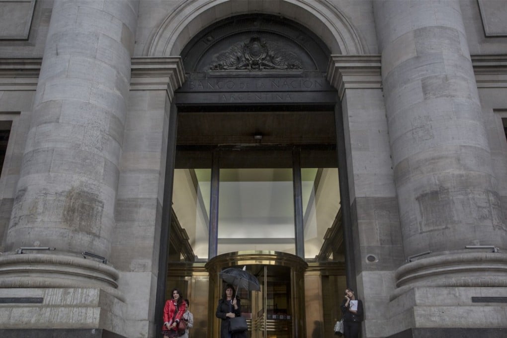 Pedestrians stand outside the Bank of the Argentine Nation in Buenos Aires on May 10. Argentina is facing stormy economic weather as the value of the peso has slid in recent weeks. Photo: Bloomberg