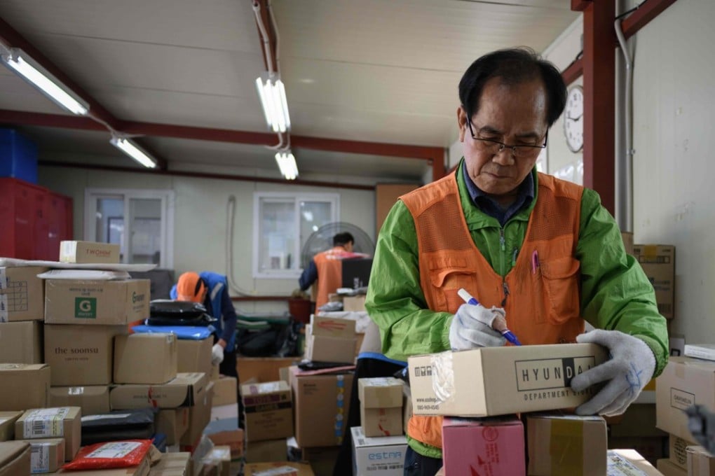 Working pensioner Park Jae-yeol, 71, sorts his packages before delivering them in Seoul, South Korea. Photo: AFP