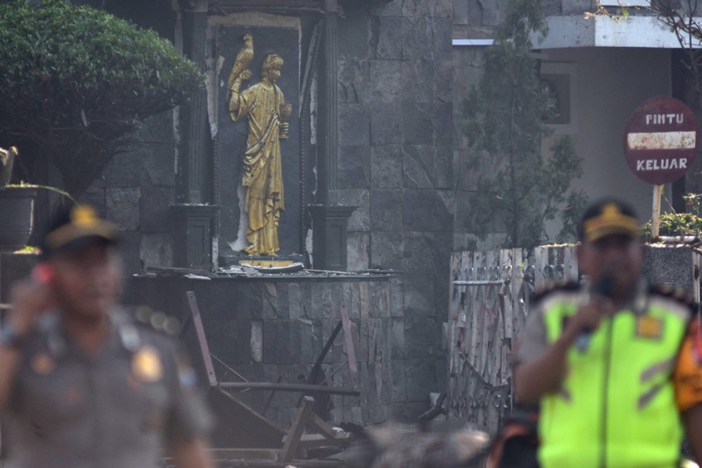 Police outside the Immaculate Santa Maria Catholic Church following a blast, in Surabaya, East Java. Photo: Reuters