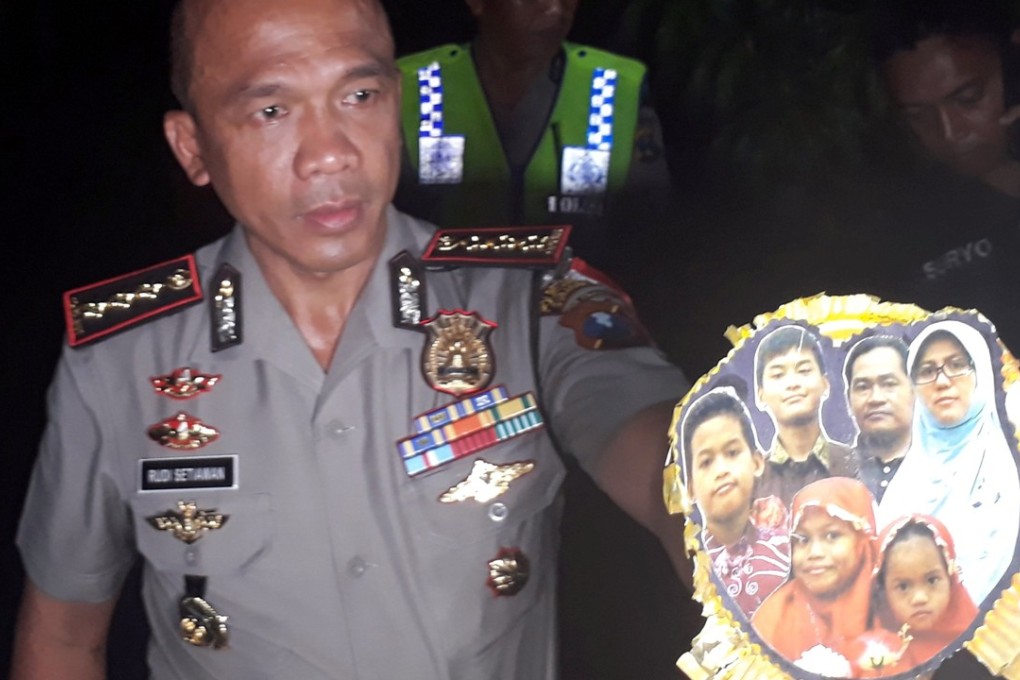 Chief of Surabaya Police, Rudi Setiawan, shows a family photo of suspected suicide bombers of the three churches in Surabaya. Photo: Reuters