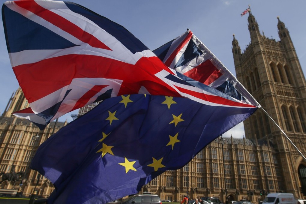 Demonstrators fly a Union Jack flag  and an EU flag outside the Houses of Parliament in Westminster, central London, in October 2017. London has been ranked as the top global financial centre, but its post-Brexit fate remains unclear. Photo: AFP