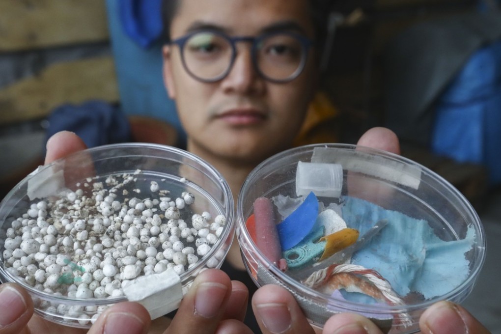 Greenpeace campaigner Andy Chu Kong shows microplastics samples found near Tung Ping Chau. Photo: Nora Tam