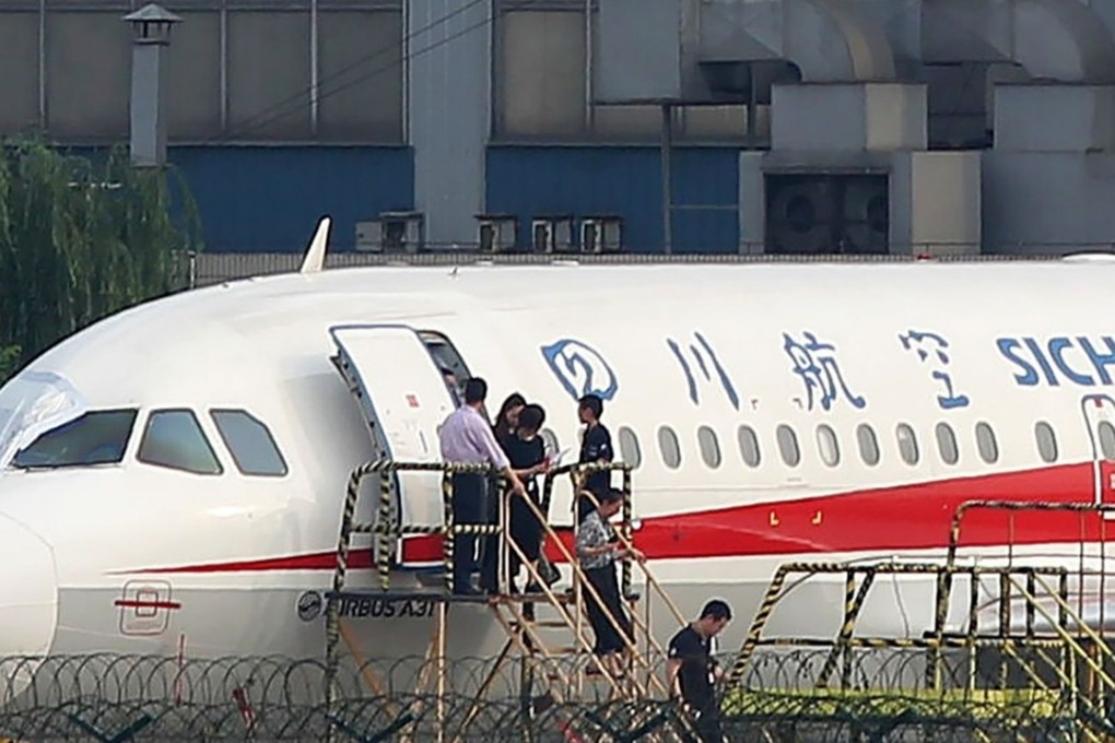 Sichuan Airlines employees inspect the airbus after Monday’s incident. Photo: AFP