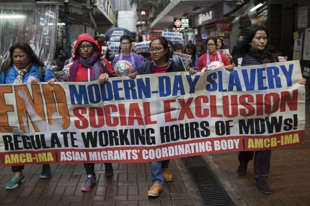 Migrant domestic workers and activists spell out their demands as they march to celebrate International Women’s Day, in Hong Kong on March 8. There were around 370,000 foreign domestic helpers in Hong Kong as of 2017, mostly from the Philippines and Indonesia. Photo: EPA-EFE