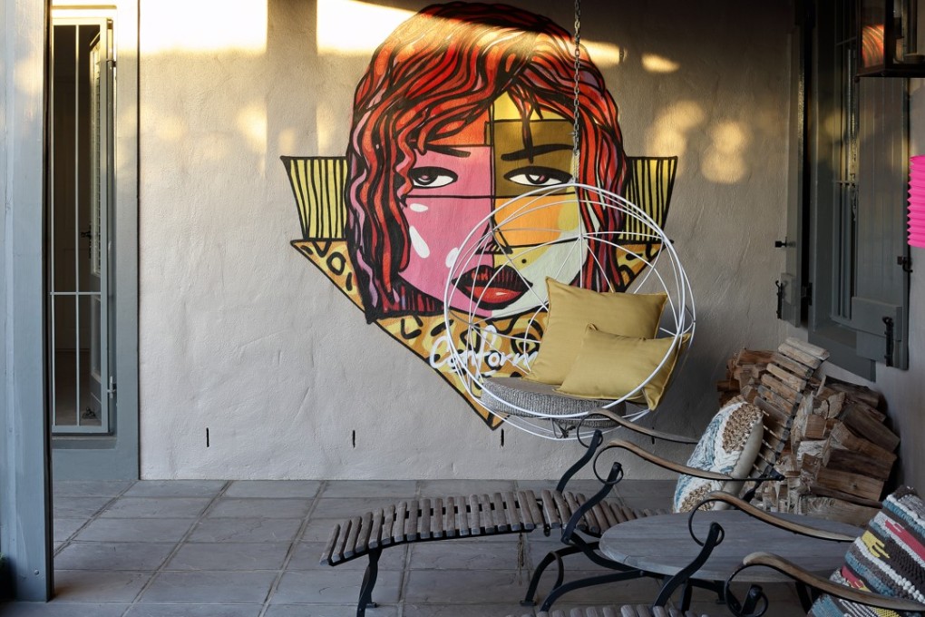 The stoep, with art by local talent Wayne Bks, is a way of life in South Africa, where a temperate climate encourages outdoor living. Photography: Henrique Wilding
